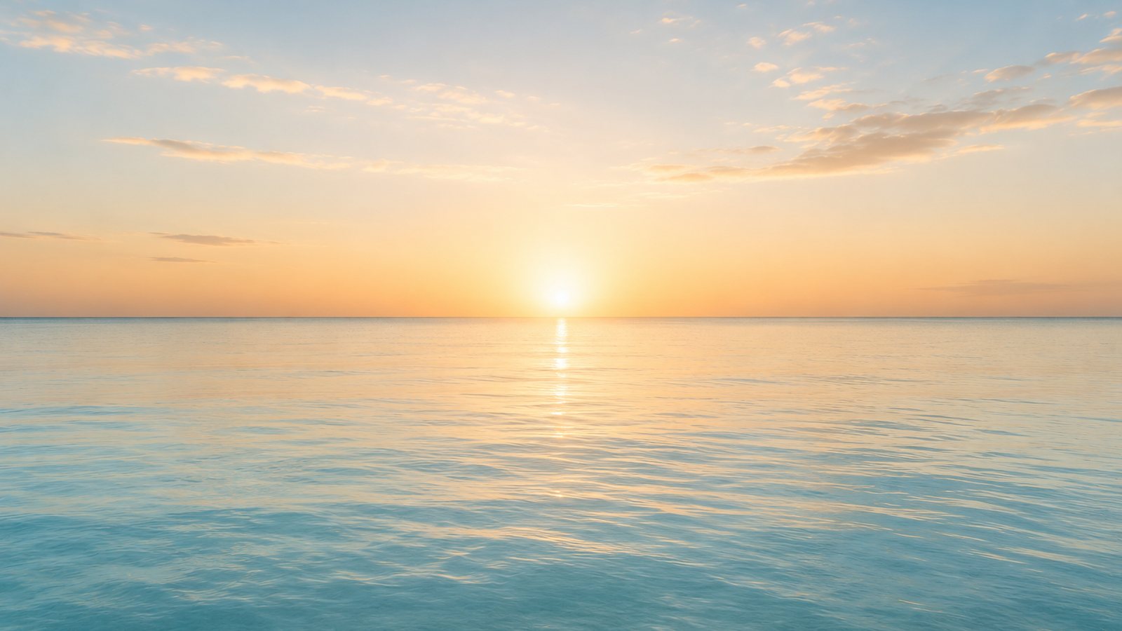 Sunrise over open, still water